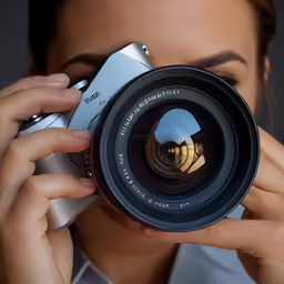 woman holding up a camera and taking a photo