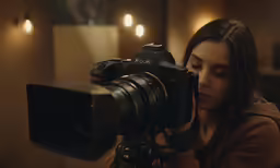 a woman that is taking pictures with a camera