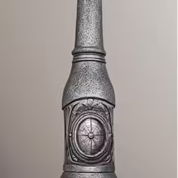 a large metal vase sitting on top of a wooden table