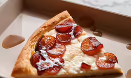 a slice of pizza in a white paper tray