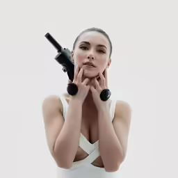 woman in a white dress holding a gun
