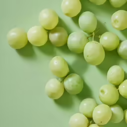 a bunch of grapes scattered on top of a green table