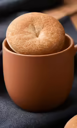 three round bread rolls in a small bowl