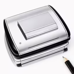 a crick pen next to a stapler and sharpener