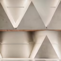 four triangulars on the wall above the table
