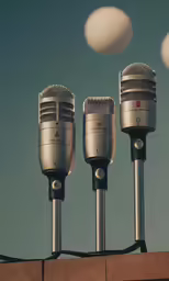 three microphones are attached to a wall, near two white balls