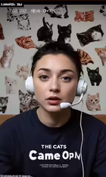 there is a woman with headphones on and cats drawn on the wall