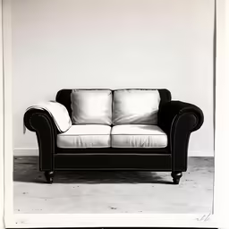 a black and white sofa sitting against a wall