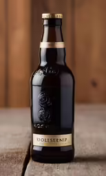 a brown beer sitting on top of a wooden table