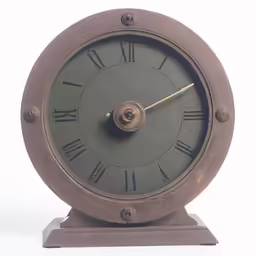 an antique metal clock with roman numerals sits on a wooden stand