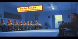 a man sitting in a room with lots of chairs