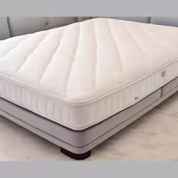 a close up of a mattress on a white couch
