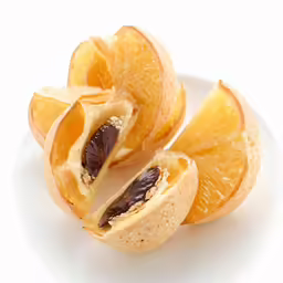 a peeled orange and some seeds on a plate