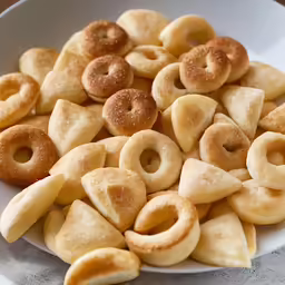 a plate full of donuts in small stacks