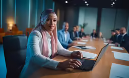 a woman with her laptop computer on a conference table