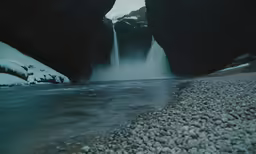a body of water surrounded by large rocks