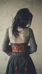 woman in a dark dress with one arm around her back