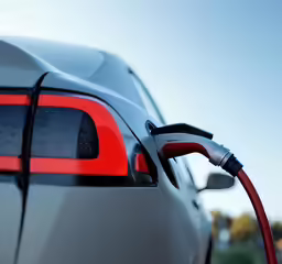 an electric car is charging on the side of the road
