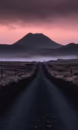 an empty road leading to the top of a mountain