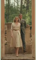 a young woman is standing near a man outside