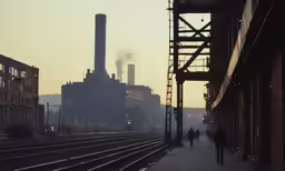 the factory on a city street with trains in front