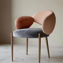 a gray and tan chair with two round pillows on top