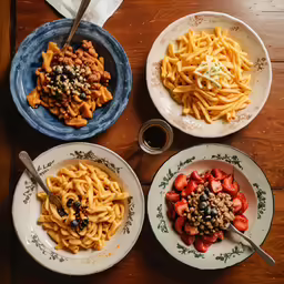 three plates of food with pasta and other foods