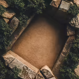 a small bed sitting in a stone garden