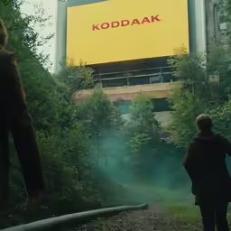 a person is walking away from the billboard
