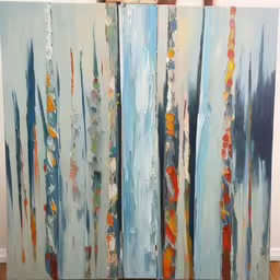 a painting that is sitting on the floor,a painting on a wooden floor in front of a wall
