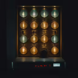 a golden clock is on display in the dark