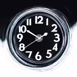 a black clock with numbers written on the face