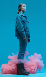 a woman stands on a cloud of smoke
