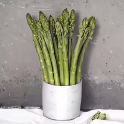 green beans in a white ceramic container on top of a sheet