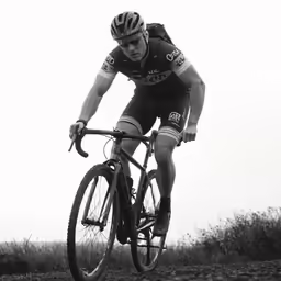 a person on a bike rides on a field