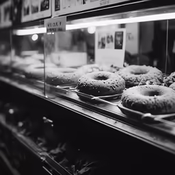some donuts are displayed in a glass case