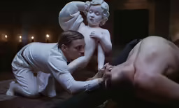 a woman kneeling down next to a man