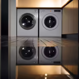 two washing machines are reflected in the mirror