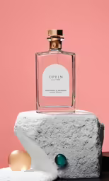 a bottle of perfume sitting on top of a rock