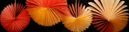 three different colored folded paper fans on display