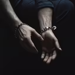 two people hold hands with their hands together