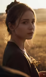 woman posing in field in golden light