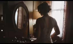 a woman in a short dress looking into a mirror