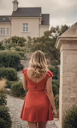 a lady that is walking on the sidewalk