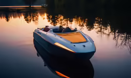 an empty motor boat in the water near the shore