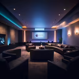 a fancy sitting area with dark leather furniture and lighting