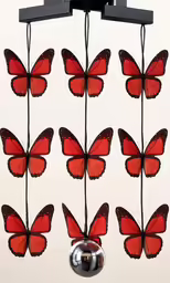 there are many orange butterflies hanging from the ceiling