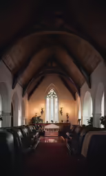 a large church with stained glass windows and long bench
