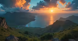 a sunset from a high mountain overlooking the ocean