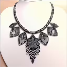 a necklace on a mannequin that has an ornamental decoration on it,an artistic necklace hanging from a display mannequin